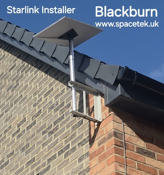 Starlink dish on a pole above the roof edge of a brick new-build property in Blackburn