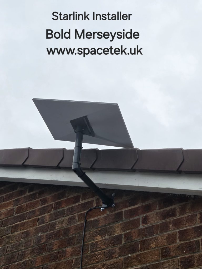 Starlink dish on a dark angled wall mount below the roof edge of a brick bungalow in Bold Merseyside