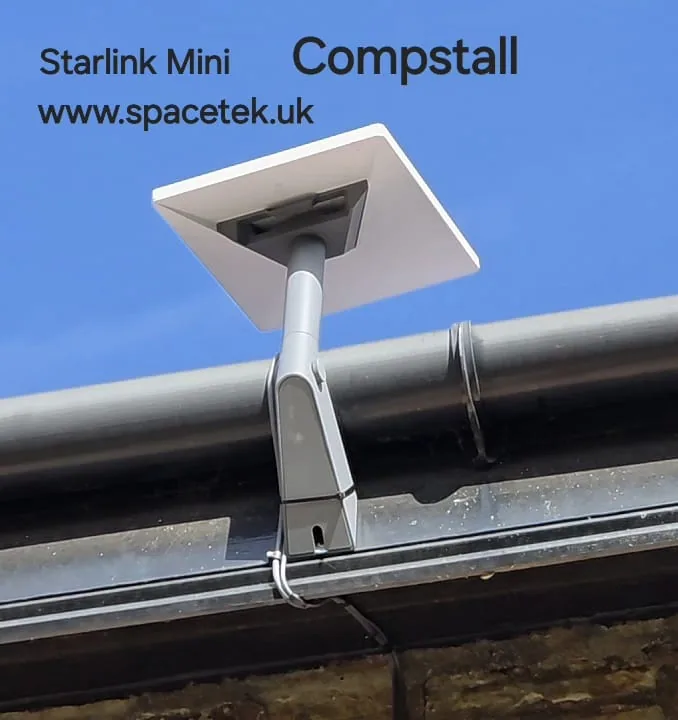 Starlink Mini on a short grey mount beside the gutter of a property in Compstall