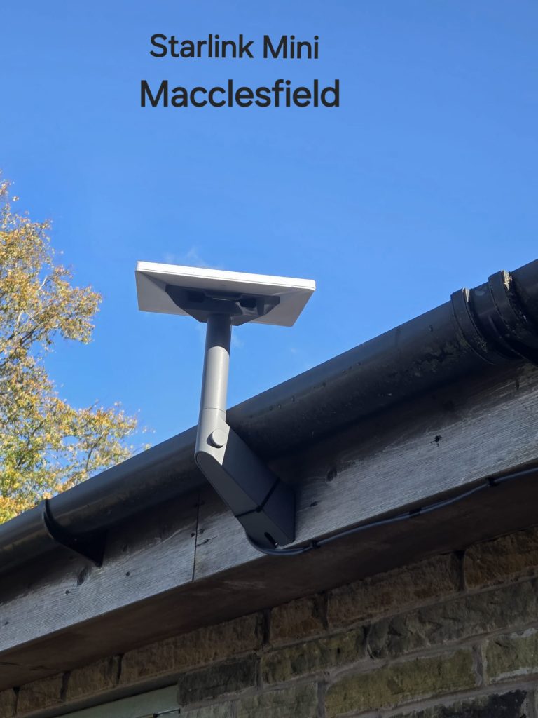 Starlink Mini on a grey mount beside timber fascia and guttering at a stone property in Macclesfield