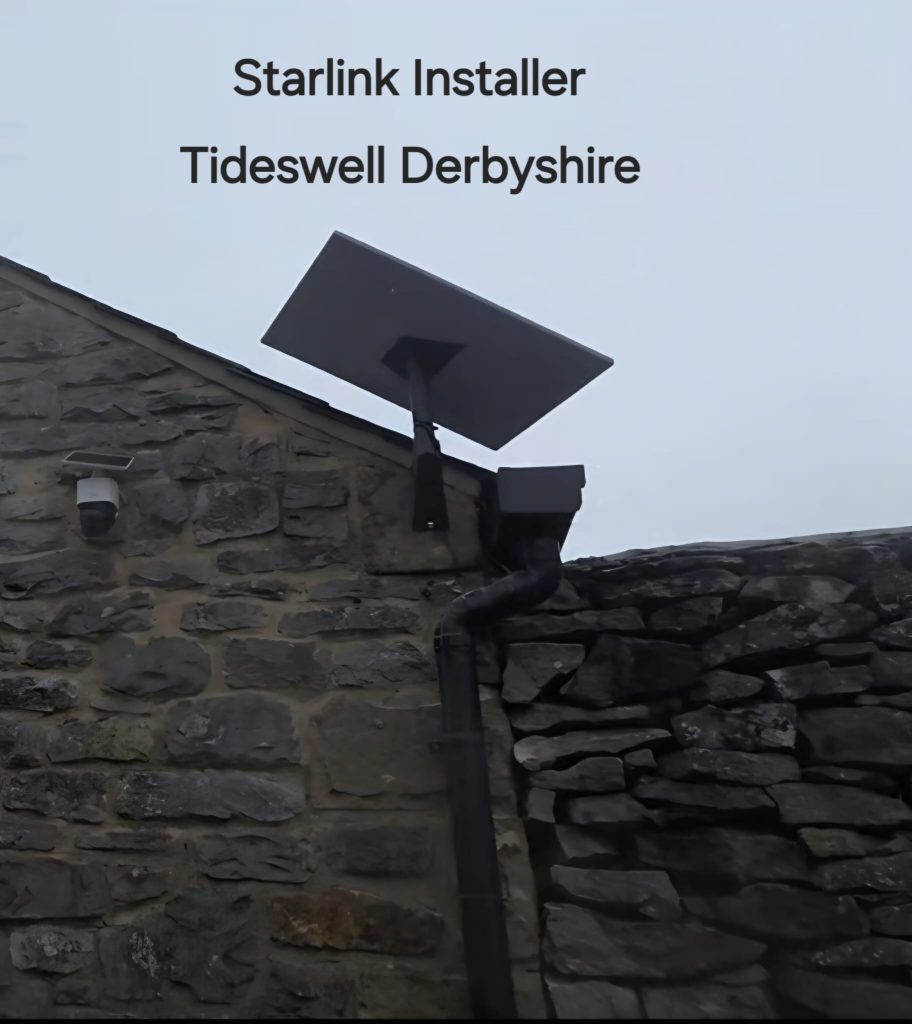 Starlink dish mounted near the top of a stone wall beside guttering in Tideswell Derbyshire