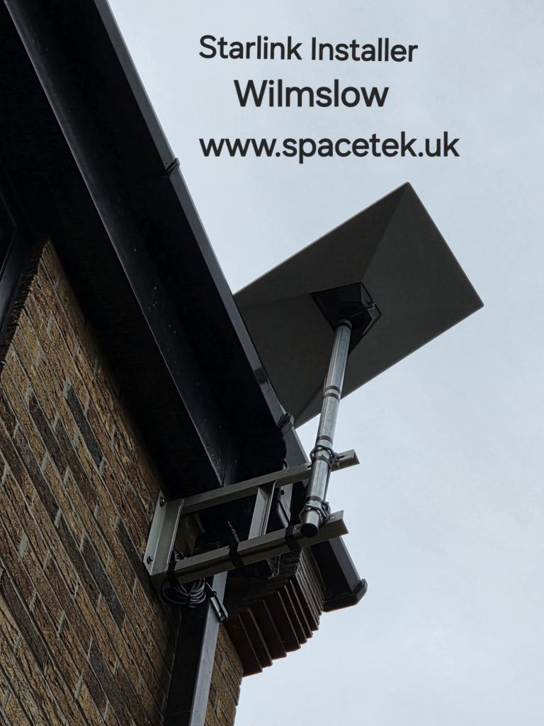 Rectangular Starlink dish on a pole fixed to a Wilmslow property with two wall brackets