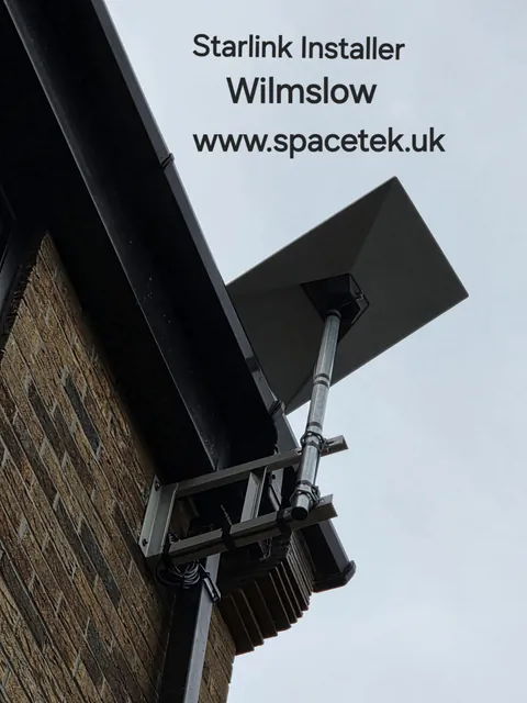 Rectangular Starlink dish on a pole fixed to a Wilmslow property with two wall brackets